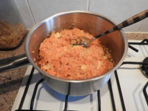 onion, carrot and rice in a pan