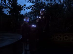 Family wearing Bright Eyes hats with eyes lit up