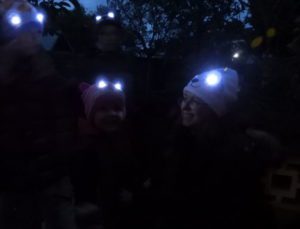 Mum and boy wearing Bright Eyes hats with eyes lit up