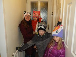 Family wearing Bright Eyes hats