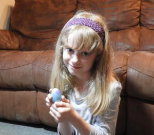 Girl holding toy egg