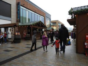 Father and children walking past Christmas market