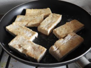 tofu slices frying in pan