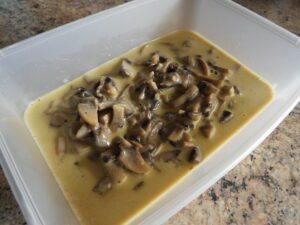 Creamy vegan mushroom pasta sauce in tub